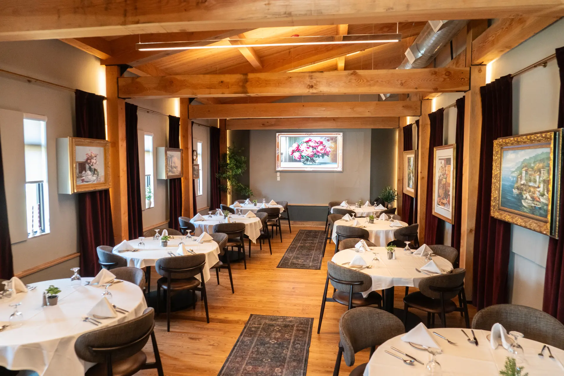 Joey's banquet room with round tables set in white linen