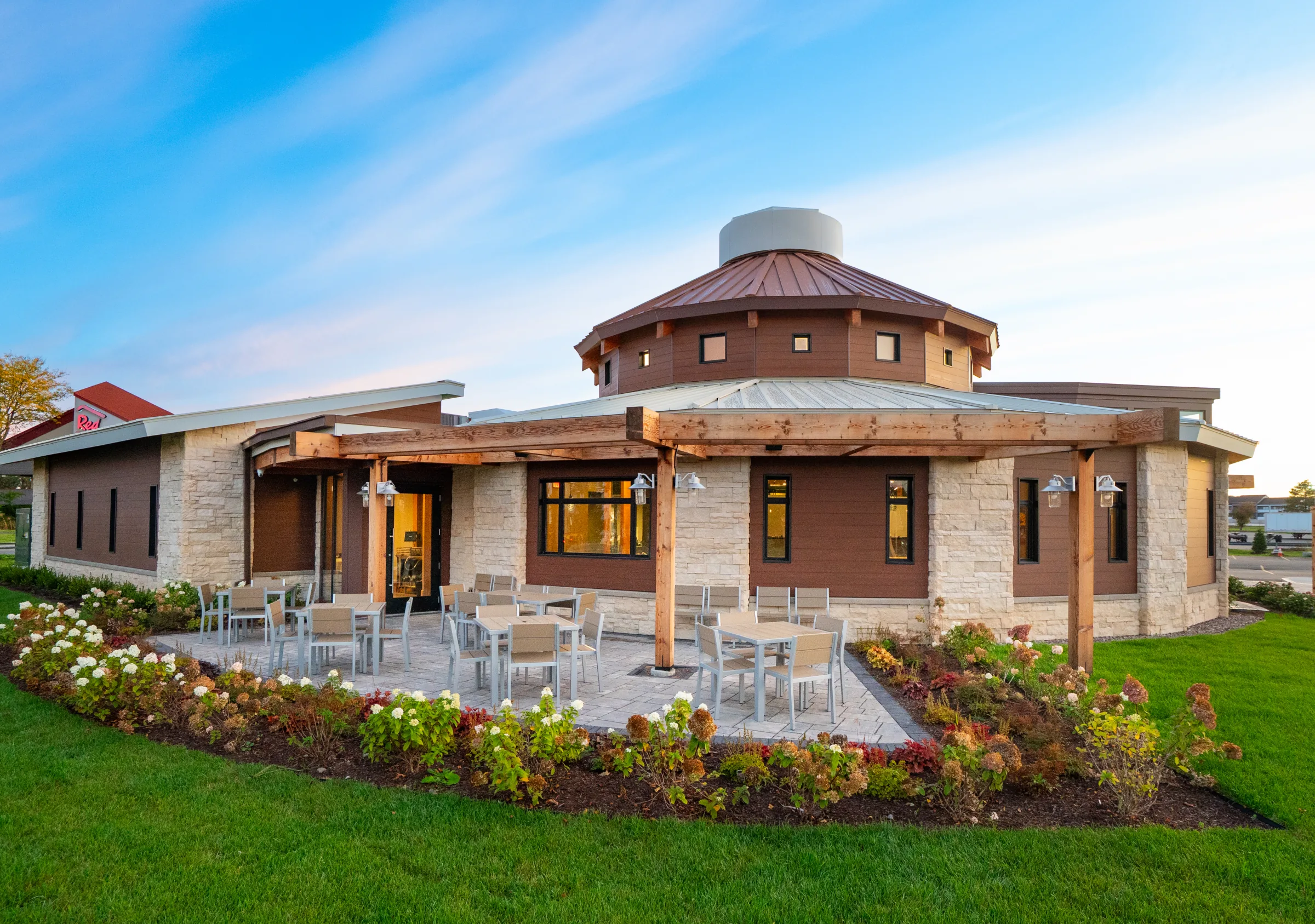 Joey's circular dining room and landscaped patio at sunset